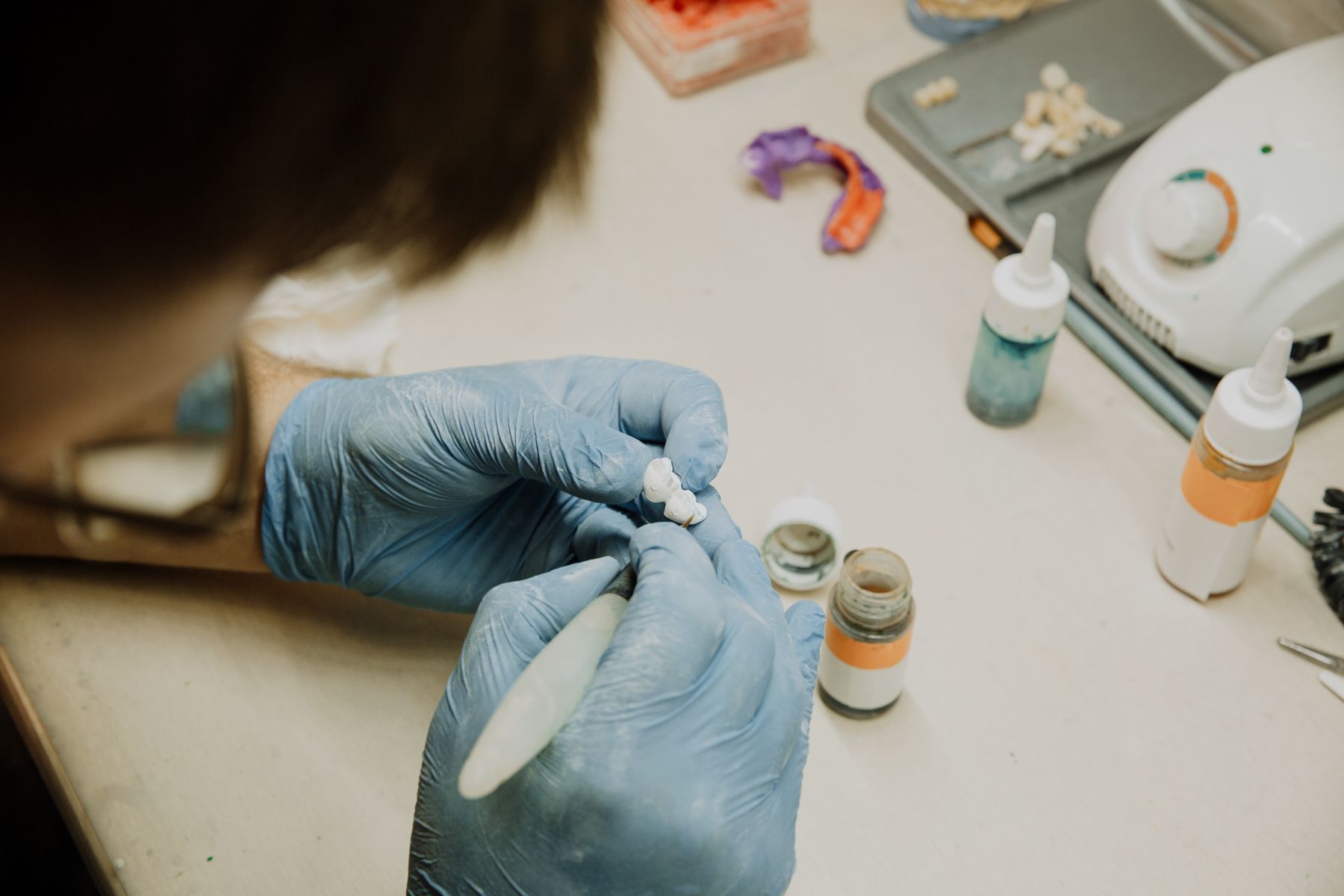 Technician refining a dental restoration